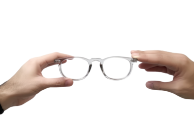 Pair of Hands Holding a Pair of Glasses. A photograph showing a pair of hands securely grasping a pair of glasses.