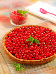 Tart with chocolate and red currants.