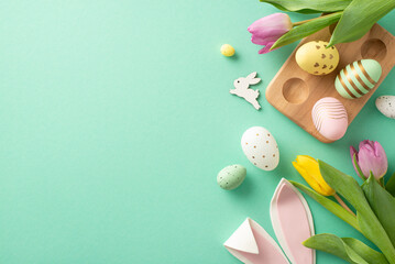 Festive Easter vibes! Top view of color-popping eggs in wooden holder, bunny ears, and tulips....