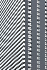 Minimalistic photo of a part of a modern grey and white apartment building