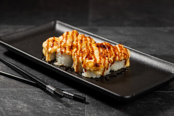 Sushi menu on dark plate with stone texture