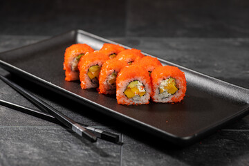 Sushi menu on dark plate with stone texture