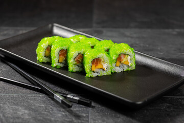 Sushi menu on dark plate with stone texture