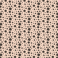 simple texture made from circles of different sizes on a beige background.