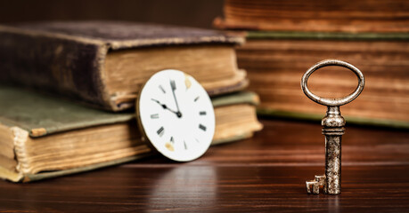 Success key with books and clock face. Life coaching, mentor, solution banner.