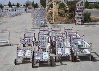 Turkmenistan. Ashkhabad market. Handmade baby carriages with colorful ornaments. - 735959612