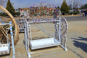 Turkmenistan. Ashkhabad market. Handmade baby cradles with colorful ornaments. - 735959696