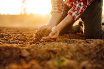 Farmer holding soil in hands close-up. Agriculture, gardening, business or ecology concept.