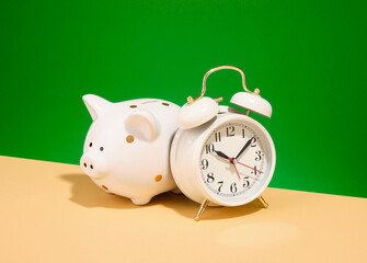 Retro alarm clock and piggy bank. Wake up and saving money for dreams.
