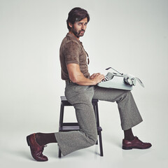 Man, vintage and pipe with typewriter in studio on grey background, confident and typing in chair....