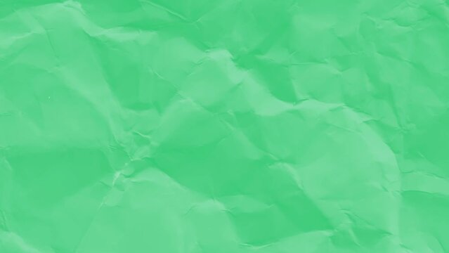 green crumpled paper background texture. Stop motion animation. Seamless looping