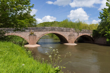 Fototapeta na wymiar The road bridge over the River Monnow at Skenfrith built in 1824. Monmouthshire, Wales, UK