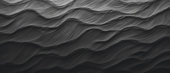 Textured layers of black sand dunes.