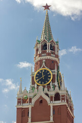 Spasskaya tower of the Kremlin with a clock against the background of the blue sky in Moscow on Red Square
