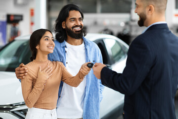 Manager Man Giving New Auto Key To Young Indian Family