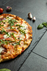 pizza menu on dark plate with stone texture