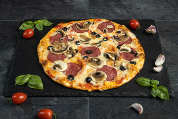pizza menu on dark plate with stone texture