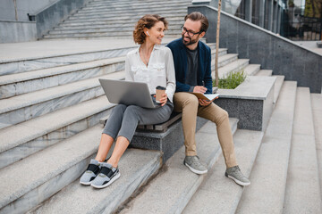 man and woman working together in park