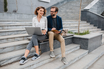 man and woman working together in park