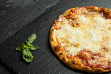 pizza menu on dark plate with stone texture