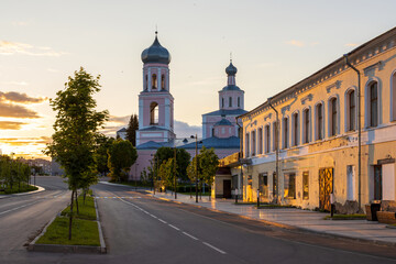 Fototapeta na wymiar Valday (Valdai), Novgorod region, Russia. The historical center of the small town of Valday. View of the Trinity Cathedral. Tourist attraction. Empty evening street in a provincial Russian town.