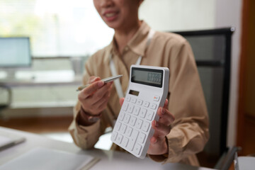 Smiling bank manager helping client to estimate monthly mortgage payment