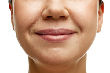 Obraz premium Cropped portrait of middle-aged woman with full moisturized pink lips and well-kept skin. Model smiling. Prevention of nasolabial folds. Concept of beauty, spa, cosmetology, skincare, anti-aging.