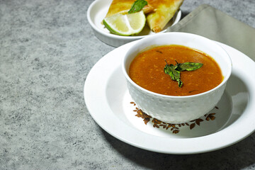 traditional bowl of spiced algerian vegetable soup named (Harira) and meat bourak named bourek. ramadan kareem