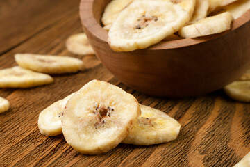 Naklejka na ściany i meble Dried bananas close-up on a wooden table.