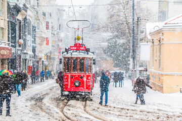 Obraz premium Istanbul, Turkey, 15 February 2021; Winter and Red Tram in Istiklal Street, Beyoglu, Istanbul.