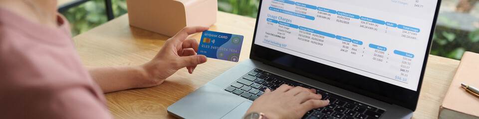 Web banner with woman paying utility bills with credit card