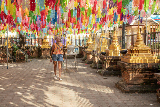 Mid aged woman solo traveller tourist is exploring the Temples in Thailand