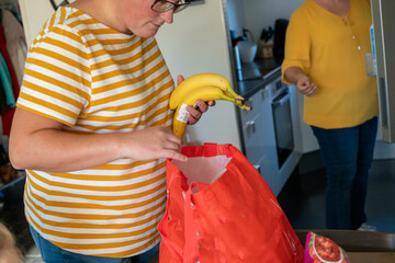 Same sex parents packing lunch for a day out