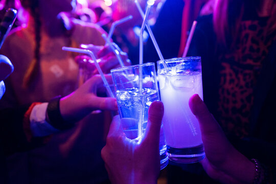 Friend celebrating with a drink in a club night out, non alcoholic drinks