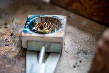 Watch maker repairing a classic watch and jewelry, authentic work place. Using small tiny tools for repairs heating up using a small furnace