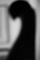 A blurry dreamy view of a hook in profile in black and white.
