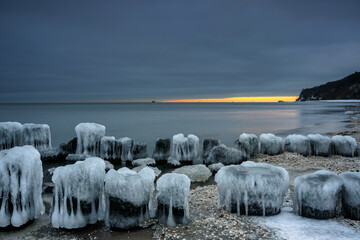 Frozen Baltic Sea beach in Babie Doły at sunset, Gdynia. Poland - obrazy, fototapety, plakaty