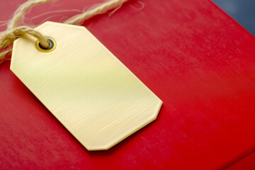 macro shot of a gold foil tag attached to a red gift box