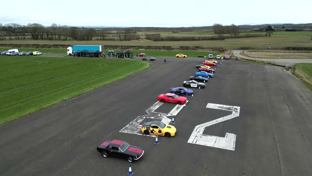 Supercars Lined Up on airport runway for trackday event exotic cars
