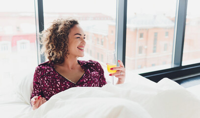 Woman on Hotel Bed Covering Self With Sheet.