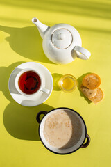 Warm and Inviting Breakfast Scene with Oatmeal, Tea, and Honey on Yellow Background