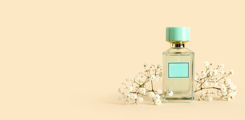 Bottle of perfume and flowers on beige background with space for text