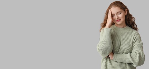 Young woman feeling awkward on grey background with space for text