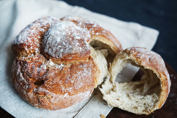 Fresh bread on a linen towel on a dark background