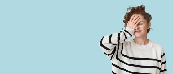 Young woman doing facepalm on light blue background with space for text - obrazy, fototapety, plakaty