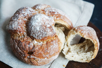 Fresh bread on a linen towel on a dark background