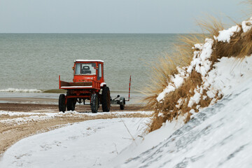 Old tractor on the seashore.