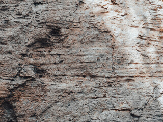 Brown cave wall stone texture for nature background.
