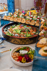 A buffet in a chic hotel with seafood, sushi, salads, fruits and pastries.