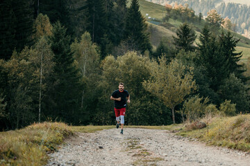 Male runner in fitness attire conquering mountain trails with determination